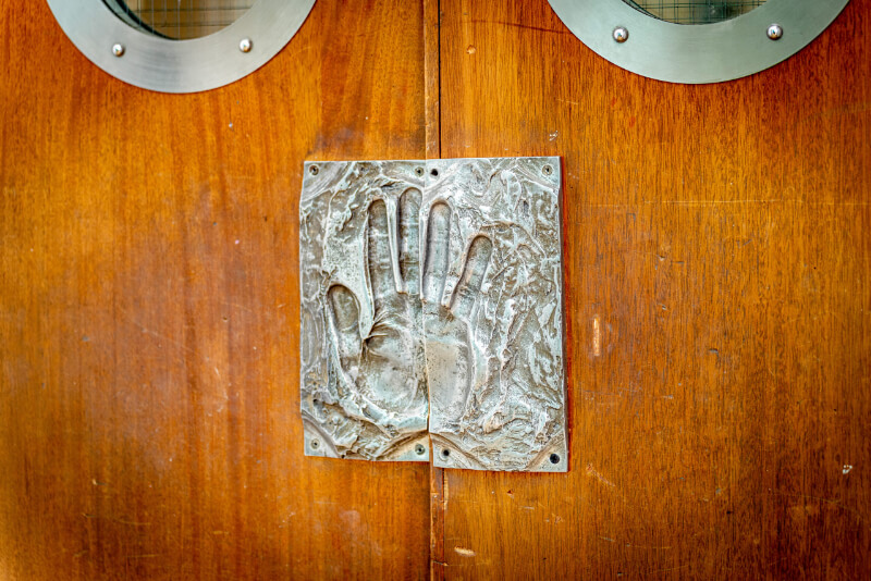 Metal handprint on door