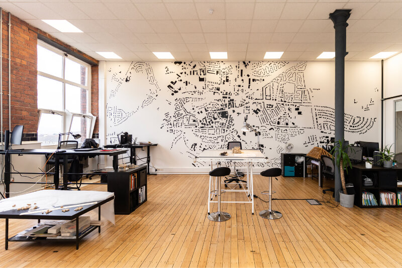 Large open plan office with drawing of Paisley on the wall